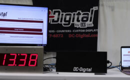 DC-Digital, Network Clock, Time of Day, Network Browser, RJ-45 Connection, Ethernet Connection, Portable Laptop, TV Screen, Flushed, DC-25, White Table, DC-Digital Logo